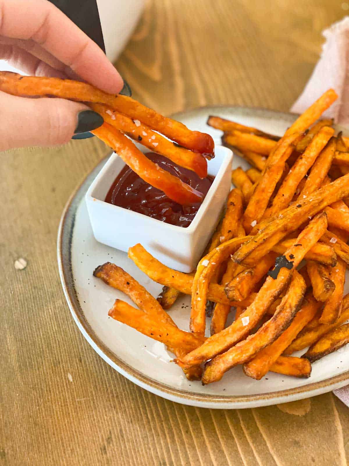 https://www.thisvivaciouslife.com/wp-content/uploads/2022/03/Frozen-Sweet-Potato-Fries-in-Air-Fryer-dipped-in-ketchup.jpg