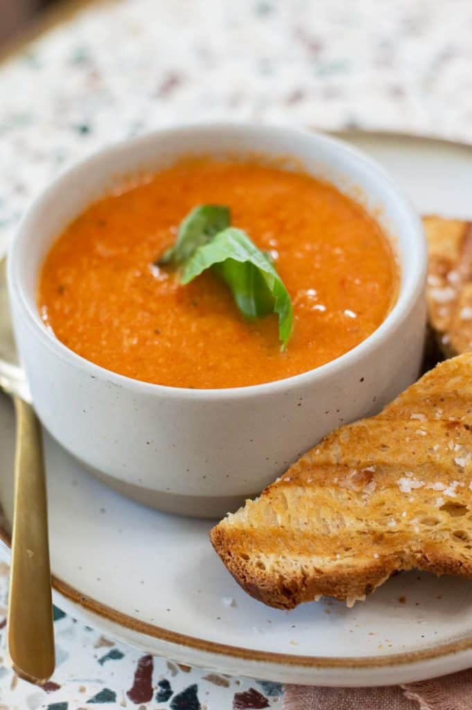 Dairy Free Tomato Soup in a bowl with basil