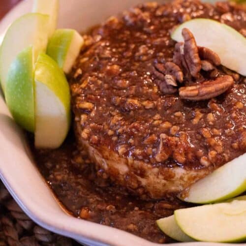 Baked Brie with Jam in a pie pan with apples and nuts