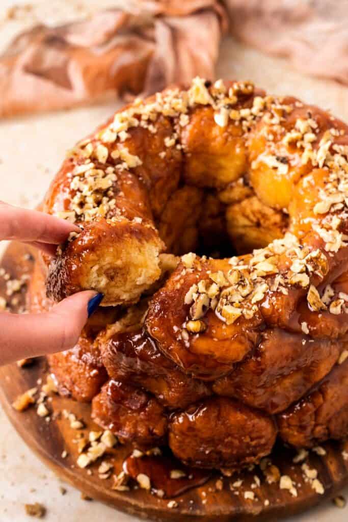 gluten free monkey bread with a hand pulling a piece out