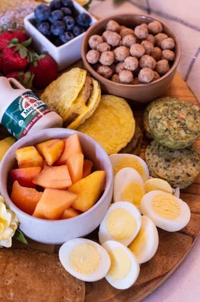 Breakfast Charcuterie Board with breakfast sandwiches, cantaloupe, eggs and more