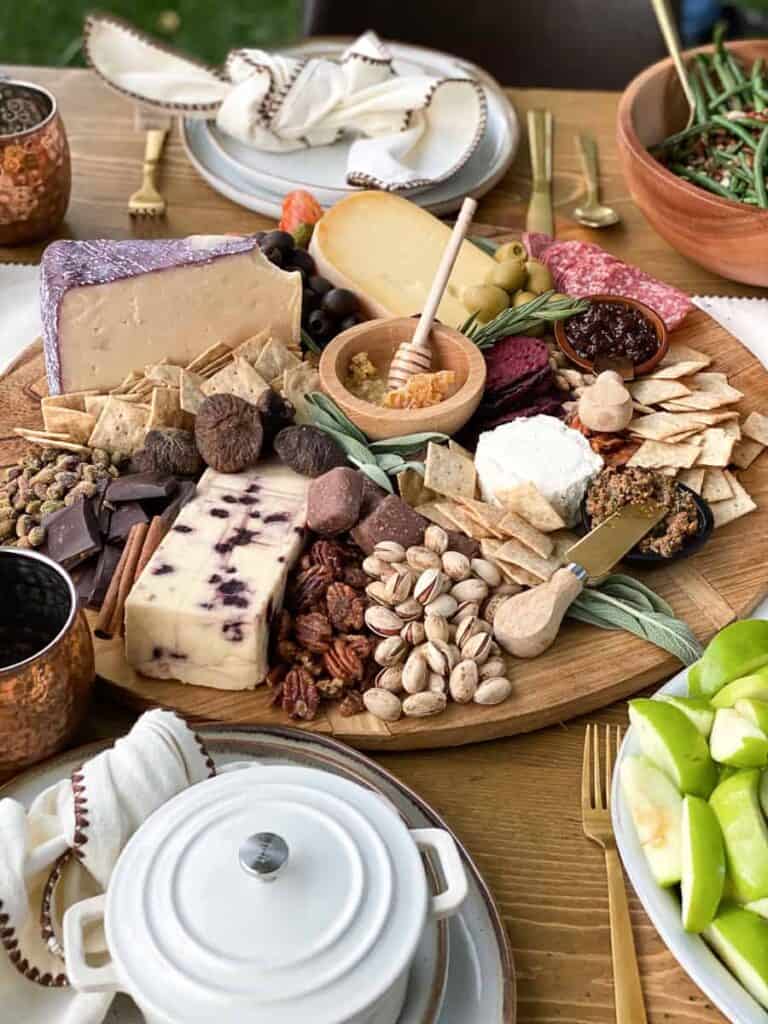 Italian Charcuterie Board on a wood platter with cheeses, cured meats and olives