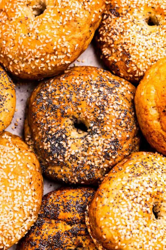 Gluten Free Bagels all next to each other some with seeds 